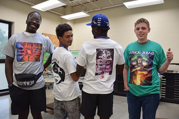 Four students standing together in a classroom