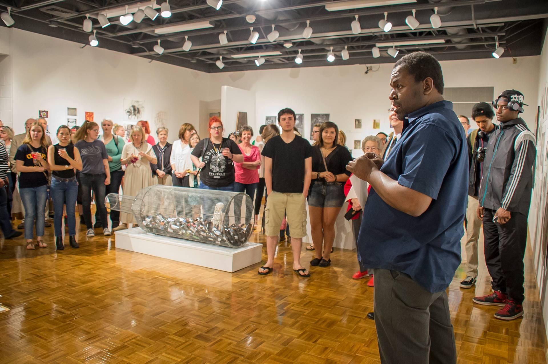 A professor talking about art pieces inside the Shircliff Humanities Building