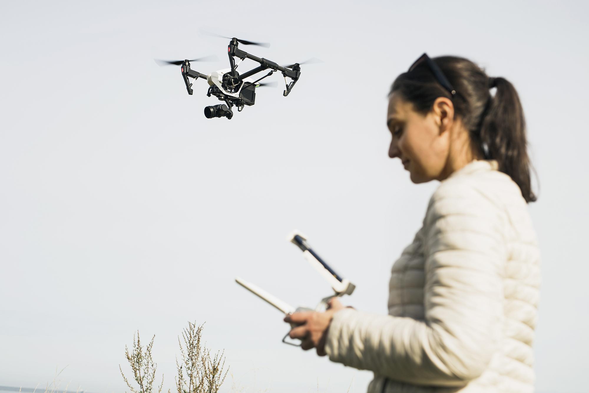 tech/woman-flying-drone-remote